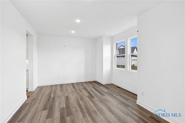 empty room with hardwood / wood-style flooring