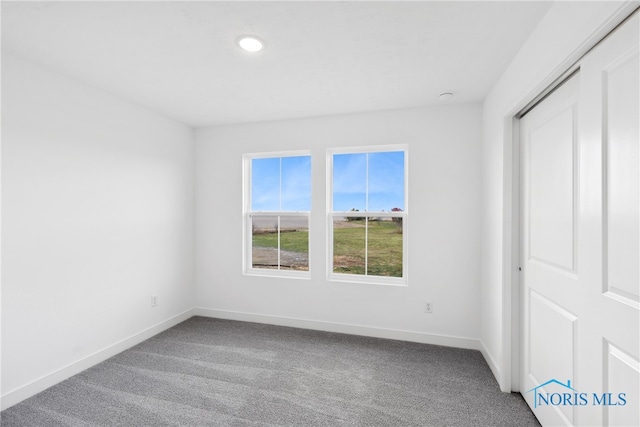 unfurnished bedroom with carpet flooring and a closet