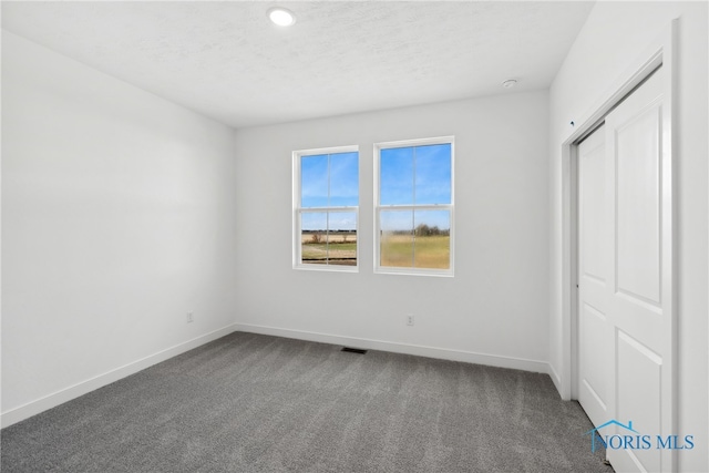 unfurnished bedroom featuring carpet flooring and a closet