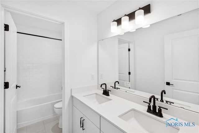 full bathroom with vanity, tile patterned floors, toilet, and tiled shower / bath combo