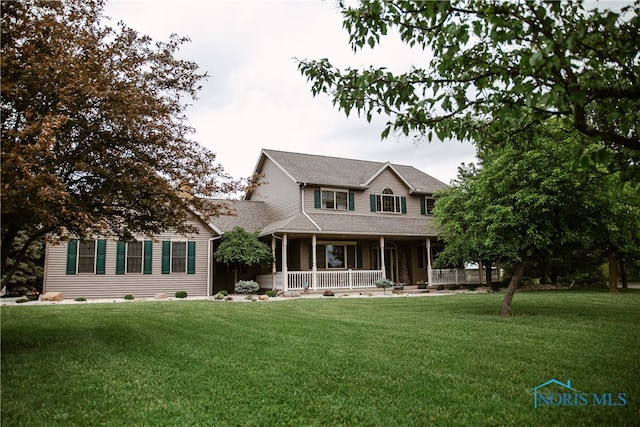 view of front of home with covered porch and a front yard