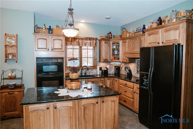 kitchen with black appliances, sink, dark tile patterned flooring, a kitchen island, and decorative backsplash