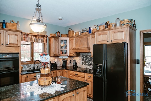 kitchen featuring black appliances, custom exhaust hood, a wealth of natural light, and sink