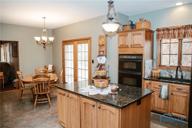 kitchen with tasteful backsplash, sink, black double oven, a kitchen island, and tile patterned floors