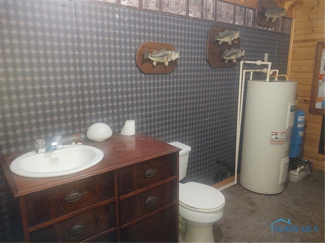 bathroom featuring wooden walls, electric water heater, tile patterned floors, toilet, and vanity