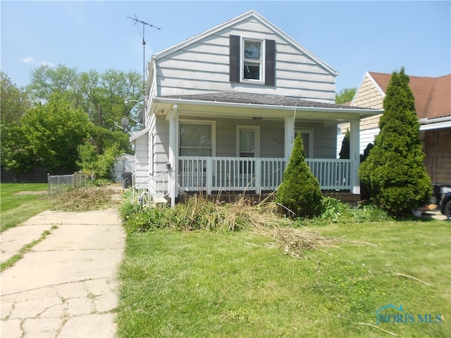 bungalow featuring a front yard and covered porch