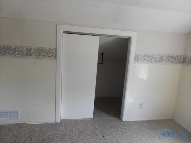 unfurnished bedroom featuring a closet and carpet floors