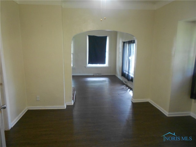 spare room with dark wood-type flooring