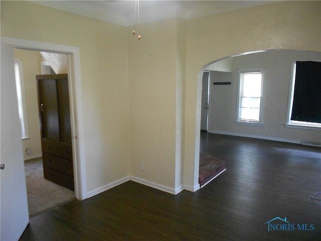 unfurnished room with dark hardwood / wood-style floors