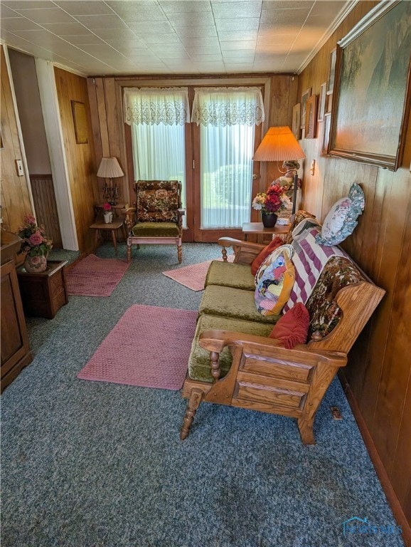 living room featuring carpet and wooden walls