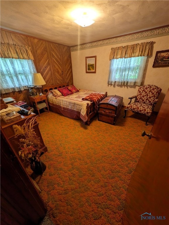 carpeted bedroom with multiple windows and a textured ceiling