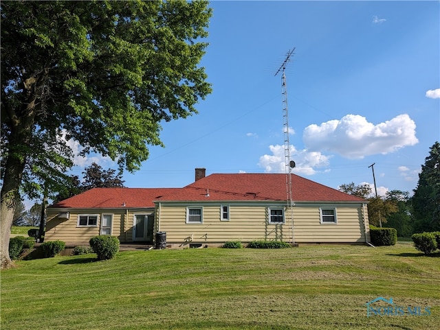 back of house with a yard