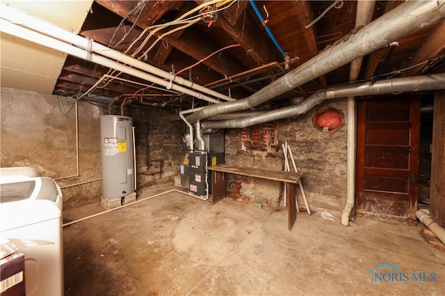 basement with heating unit, electric water heater, and separate washer and dryer