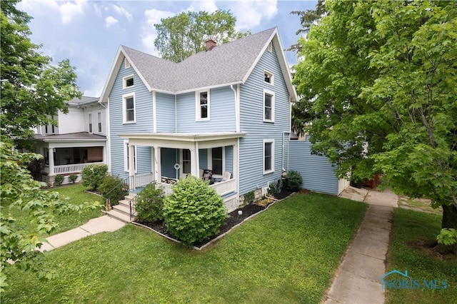 view of front property with a porch and a front yard