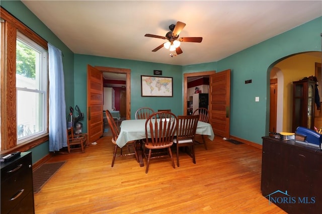 dining room with ceiling fan and light hardwood / wood-style flooring