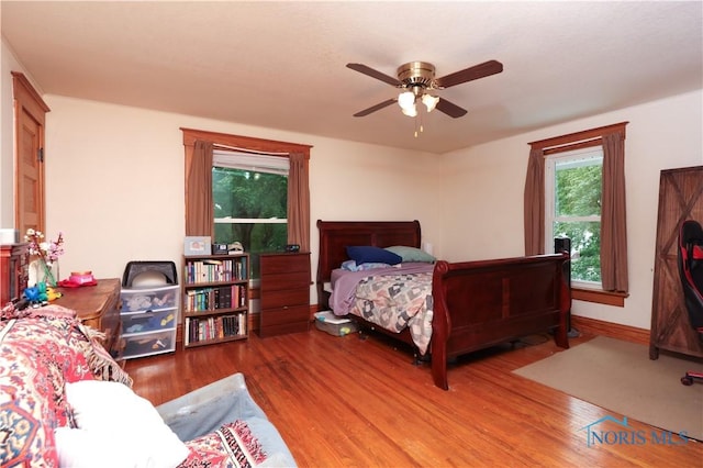 bedroom with hardwood / wood-style floors and ceiling fan