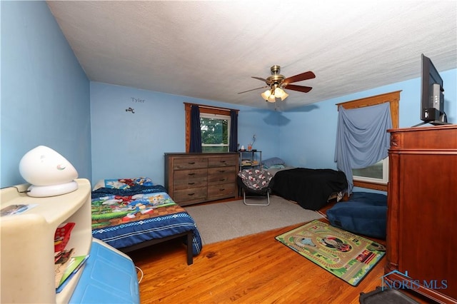 bedroom featuring a textured ceiling and ceiling fan