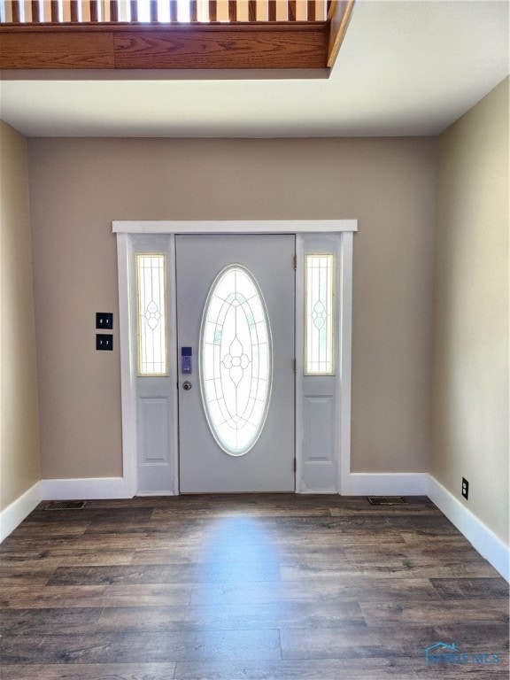 foyer entrance featuring a wealth of natural light and dark hardwood / wood-style floors