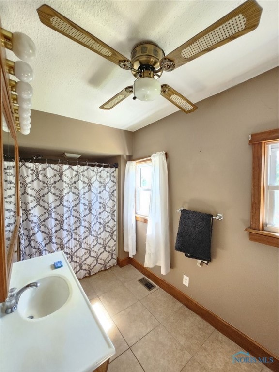 bathroom with tile floors, ceiling fan, and vanity