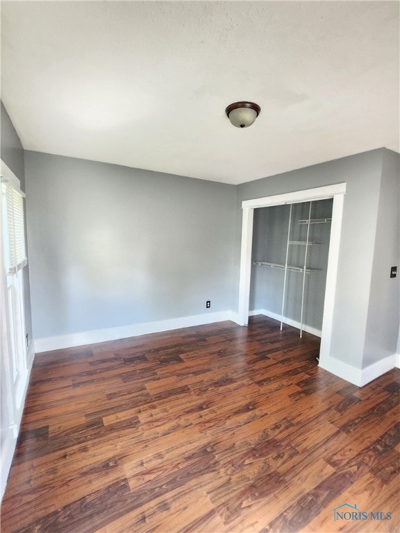 spare room with dark hardwood / wood-style floors