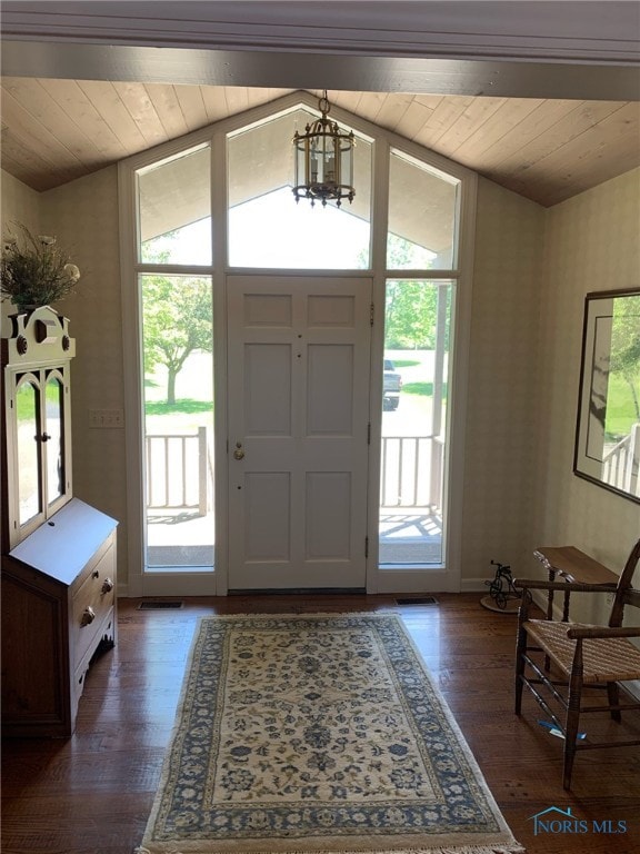 foyer with a notable chandelier, dark wood-type flooring, wooden ceiling, and vaulted ceiling