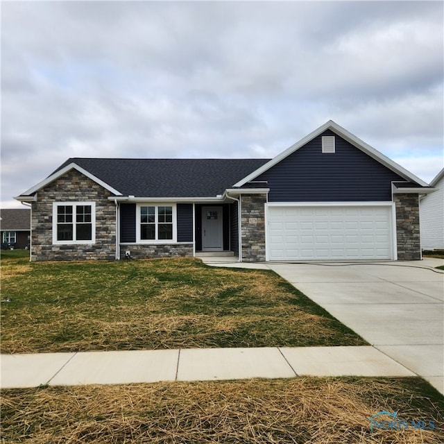 single story home featuring a front lawn and a garage