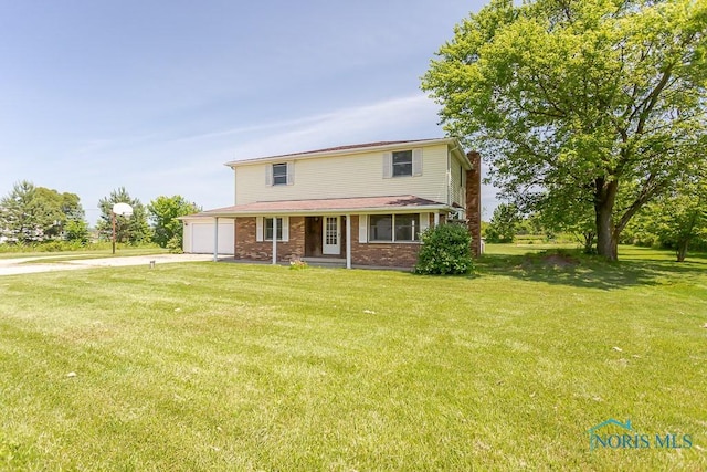 view of front of house with a porch, a garage, and a front lawn