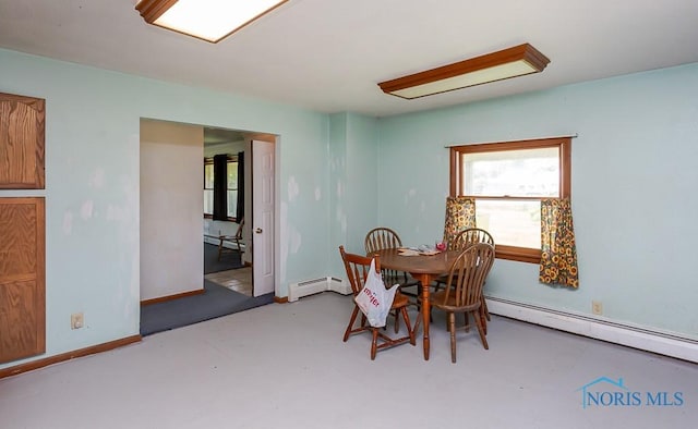 dining space with concrete flooring and a baseboard radiator