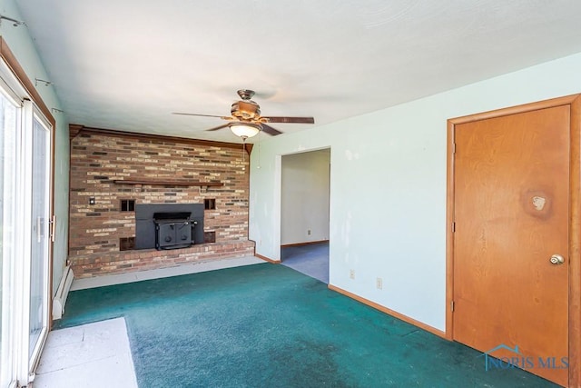 unfurnished living room with a wood stove, ceiling fan, and dark colored carpet