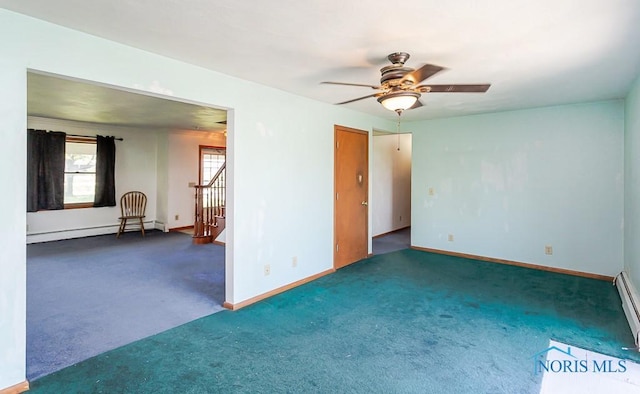 carpeted empty room with baseboard heating and ceiling fan