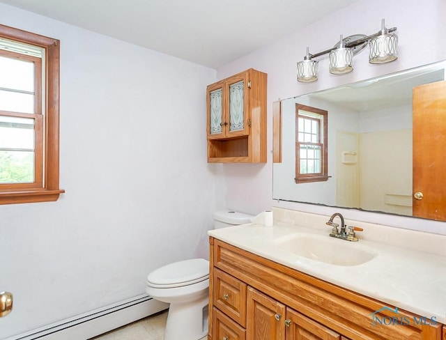 bathroom featuring tile patterned flooring, vanity, toilet, and baseboard heating