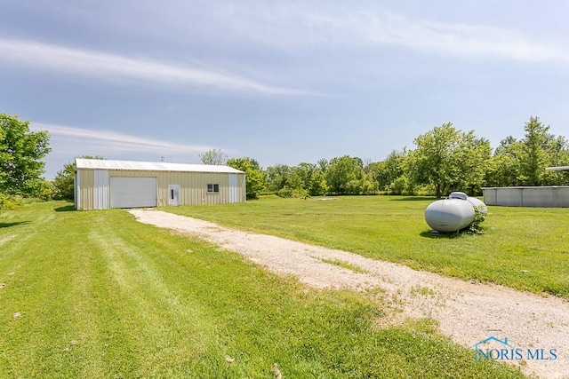 view of yard featuring an outbuilding and a garage