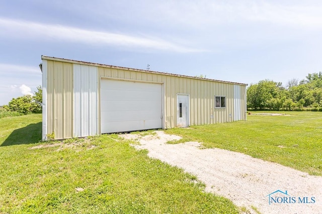 garage featuring a lawn