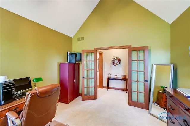 carpeted home office featuring high vaulted ceiling and french doors