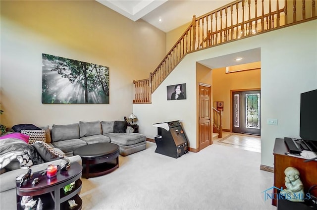 living room featuring carpet floors and a high ceiling