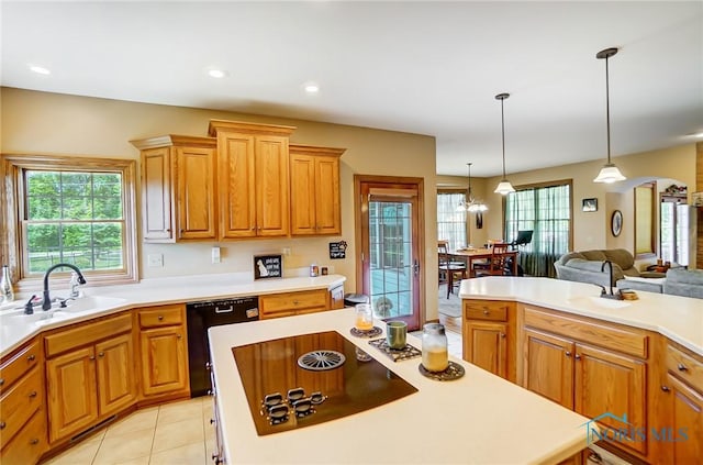 kitchen featuring an inviting chandelier, black appliances, light tile patterned flooring, pendant lighting, and sink