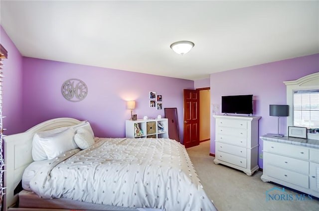 bedroom featuring light carpet