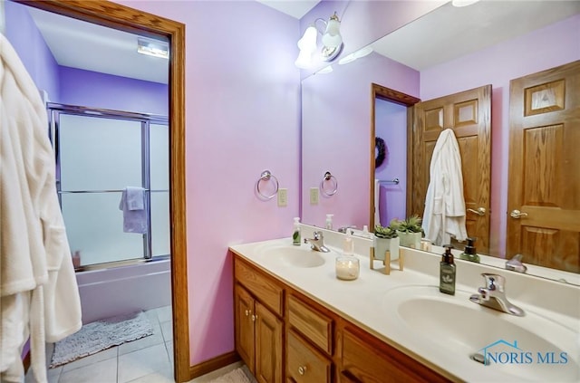 bathroom with enclosed tub / shower combo, tile patterned flooring, and vanity