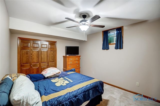 bedroom featuring ceiling fan, carpet flooring, and a closet