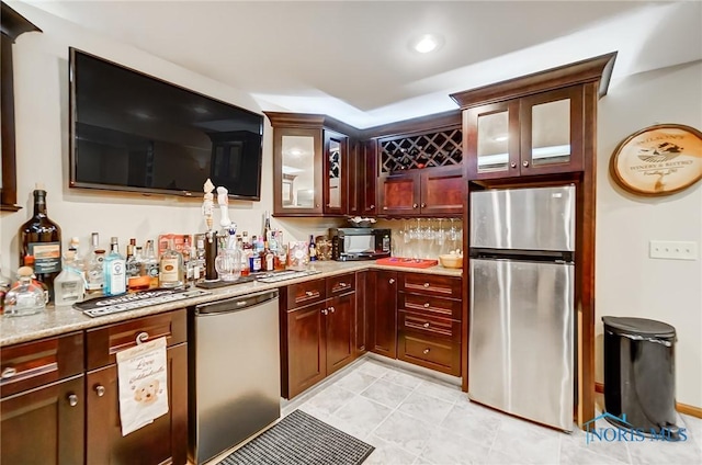 kitchen featuring light stone counters and stainless steel appliances