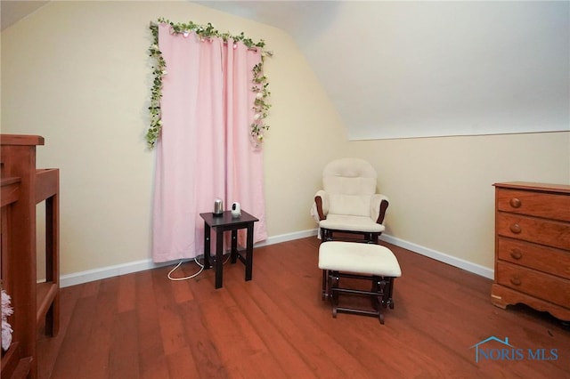 living area with vaulted ceiling and dark hardwood / wood-style flooring