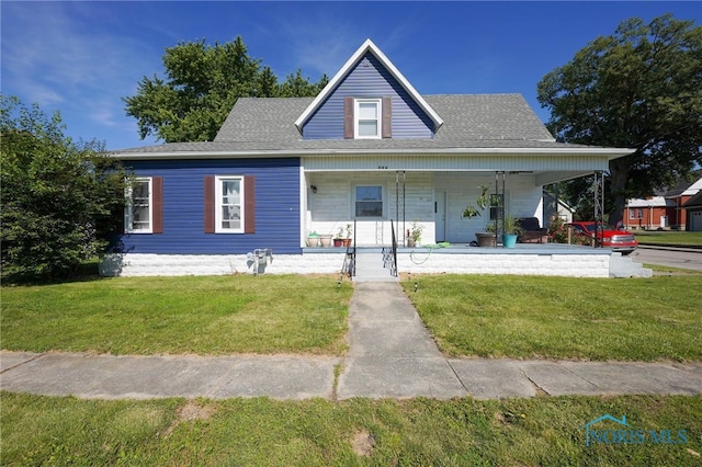 farmhouse featuring a front yard and a porch