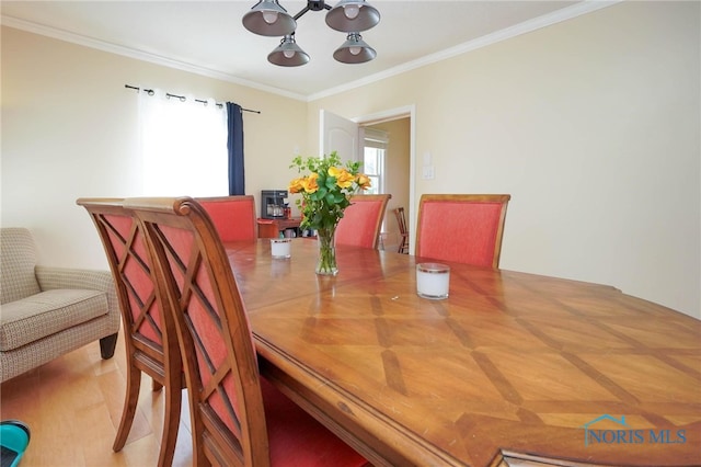 dining space featuring a notable chandelier and ornamental molding