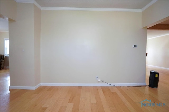 unfurnished room featuring light hardwood / wood-style floors and crown molding