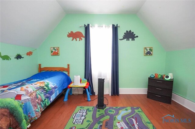 bedroom featuring vaulted ceiling and hardwood / wood-style flooring