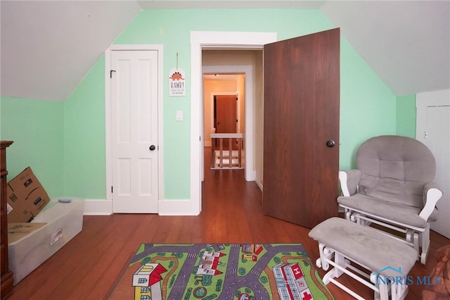 sitting room with hardwood / wood-style flooring and lofted ceiling