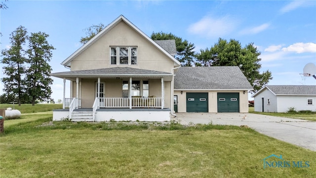 view of front of house with a front yard, a porch, and an outdoor structure