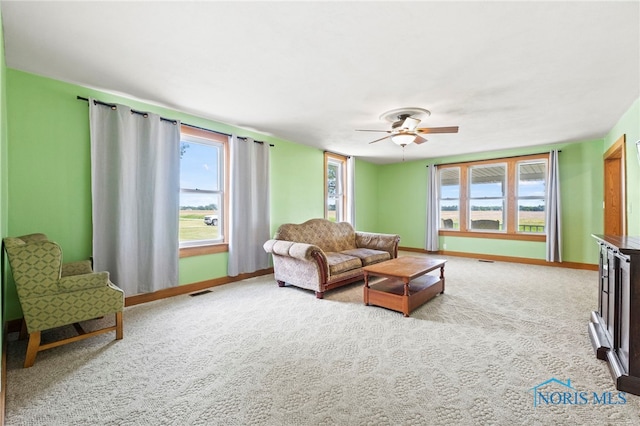 living room with light carpet and ceiling fan