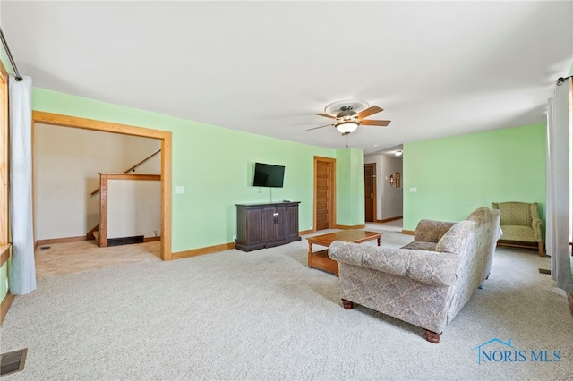 living room featuring light carpet and ceiling fan