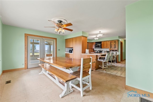 dining area with french doors and ceiling fan